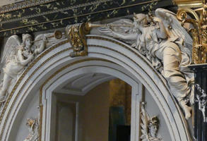 Archway framed by angels blowing horns