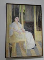 Portrait of seated woman in white robe with yellow trim