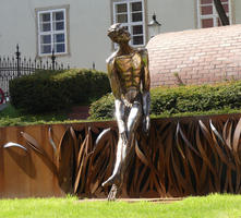 Metal scupture of seated man
