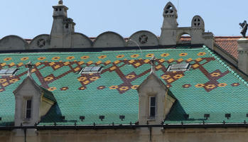 Decorative roof tiles in green, yellow, and brown geometric pattern