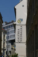 Sign for Galéria Nedbalka with line drawing of woman’s head in profile