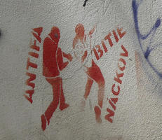 Stencil of man beating another man. Text: Antifa - beating Nazis