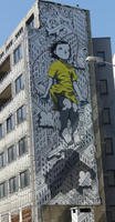 Five-story wall art of girl in yellow dress jumping rope