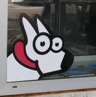 Window sticker of cartoon dog with tongue hanging out.