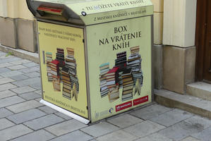 Library book return box with pictures of stacks of books on it.