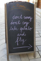 Chalkboard outside restaurant: don’t worry / don’t cry / take gelato / and fly