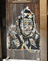 Large sticker of old woman in headscarf.