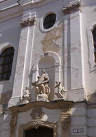 Building with arch and statuary and peeling facade