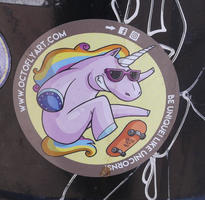 Sticker with purple unicorn with sunglasses on skateboard. Text: Be unique! Like unicorns!