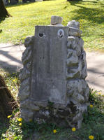Weathered gravestone with photo of decedent