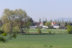 Field with houses in distance