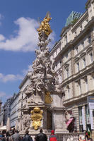 Monument with gold trim at top and on figure near base