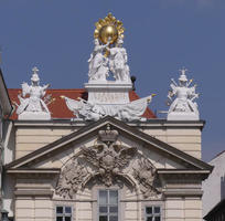 Building with sculpture and gold sphere at top