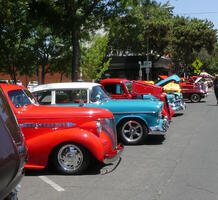 Row of brightly colored old vehicles