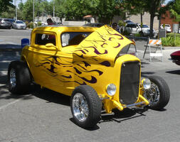Yellow “woody” roadster with black flame pttern