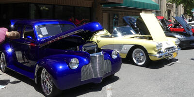 Deep blue car on left, yellow convertible on right