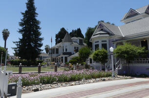 Large houses with flower gardens in front