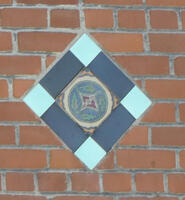 Brickwork with turquoise and blue slate diamond-shaped tile