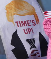 Drawing of Trump with words “Time’s Up!” where face should be.
