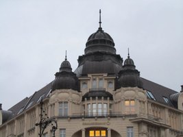 Building with three domes and ornate relief scrollwork above windows