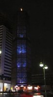 Tall church building with blue lights in windows