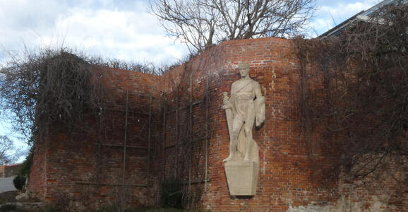 Relief sculpture of man holding sword at his side