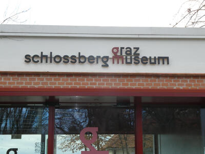 sign on Graz Schlossberg Museum; the g and m are connected