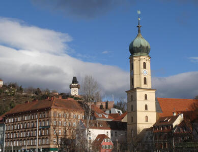 Onion dome church in foreground, Uhrturm in background.