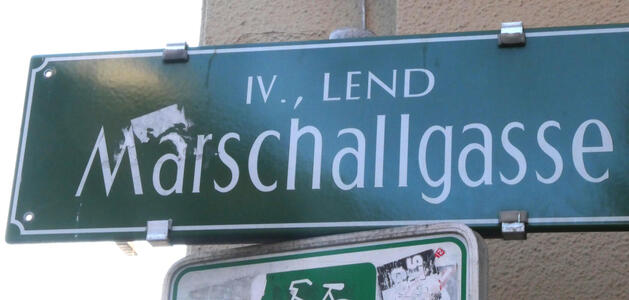 Street sign with word Marschallgasse in large type. Above it, in smaller type: IV., LEND