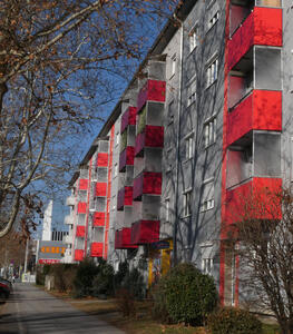 apartment building with red balconies