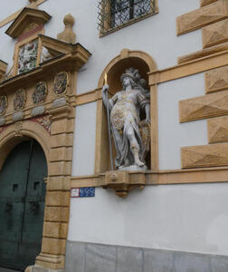 statue in front of old building