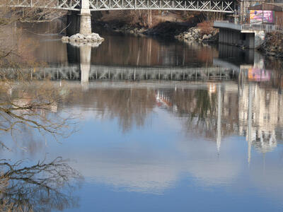 Reflection of bridge in the Mur river.