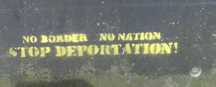 Stenciled text: No border / No Nation/ Stop deportation!