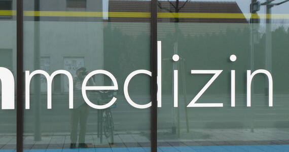 word “medizin”, where the “d” is broken up by a window frame and looks a bit like “cl”.