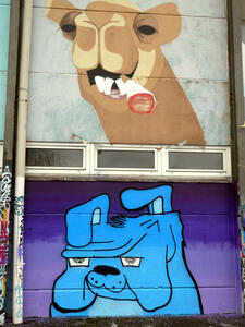 Two graffiti. Above a camel smoking a blunt. Below, a blue bulldog