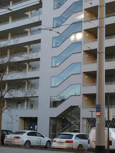 Building with windows following the line of interior staircase.