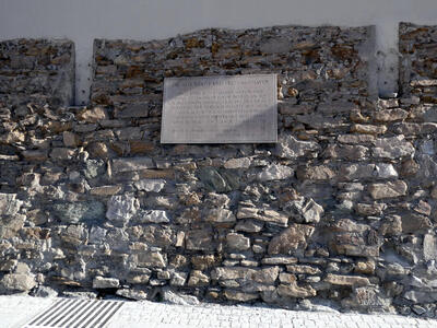 Part of old stone wall with plaque