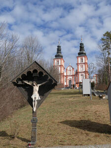 Crucifix in foreground, cathedral in background.