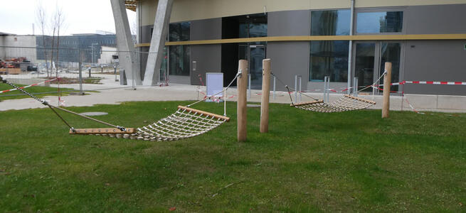 two hammocks outside apartment building