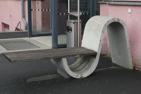 Wooden plank balanced at end of S-shaped concrete form