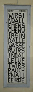 Poster with words written in a tall rectangular array with no spacing: Wir sind alle Menschen / Wir sind alle Wasser / Wir sind alle Luft / Wir brauchen alle Erde