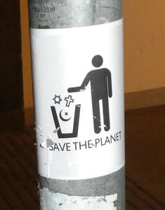 Icon of man throwing cross, crescent, and star of David into a trash can. Text: Save the planet