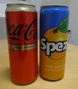 On left, Coca-Cola can no sugar, no caffeine. On right, Spezi (mix of cola and orange juice)