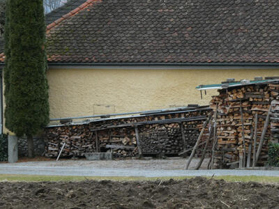 chopped wood piled up next to house