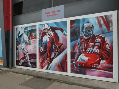 Wall painting of a tennis player, skier, and race car driver with robotic body parts and multifaceted golden eyes.