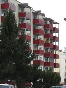 apartment building with red balconies