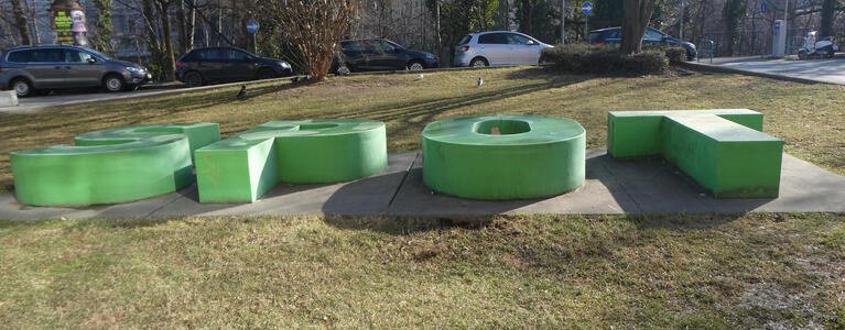 Large green letters lying on their side, spelling out SPOT.