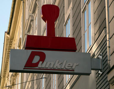 Sign for Dunkler company with a large 3-d rubber stamp