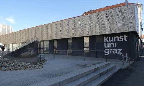 Exterior of modern building with text kunst uni graz on side