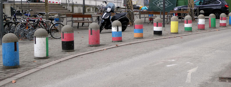 Traffic barrier posts with multi-colored stripes